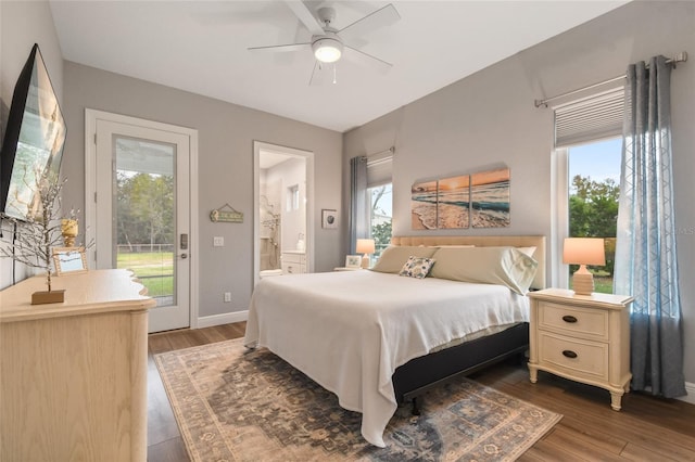 bedroom with multiple windows, ceiling fan, ensuite bathroom, and dark hardwood / wood-style floors