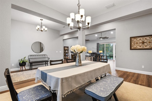 dining room featuring hardwood / wood-style floors and ceiling fan with notable chandelier