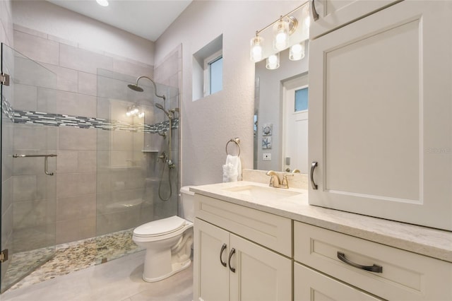 bathroom with walk in shower, vanity, and toilet