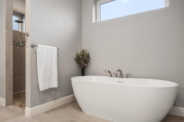 bathroom with tile patterned floors and a tub