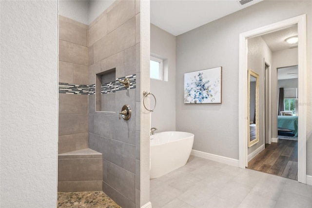 bathroom featuring hardwood / wood-style floors and shower with separate bathtub