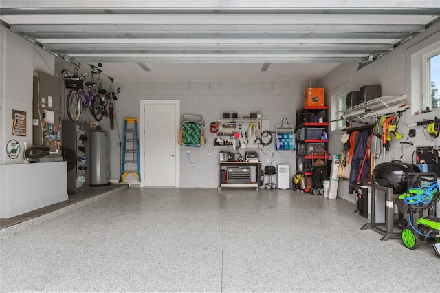 garage featuring a workshop area and water heater