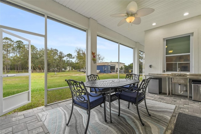 sunroom featuring ceiling fan