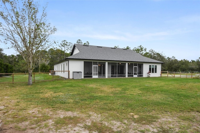 back of house with a sunroom and a yard