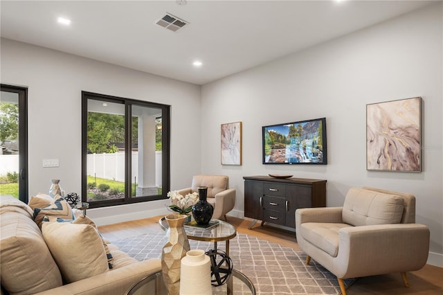 living room featuring plenty of natural light and light hardwood / wood-style floors