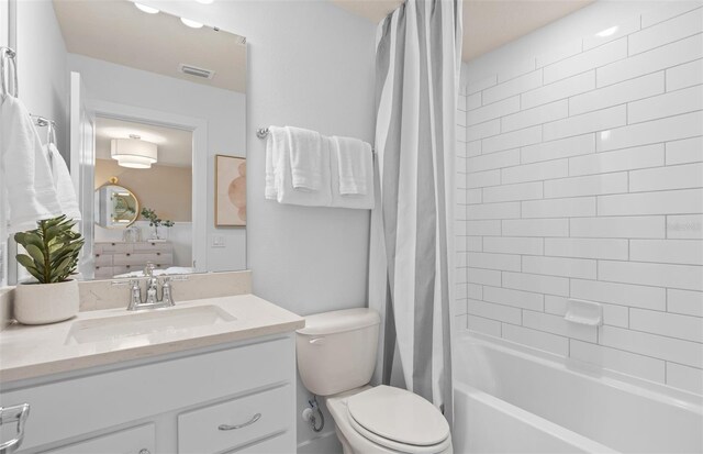 full bathroom featuring vanity, toilet, and shower / bathtub combination with curtain