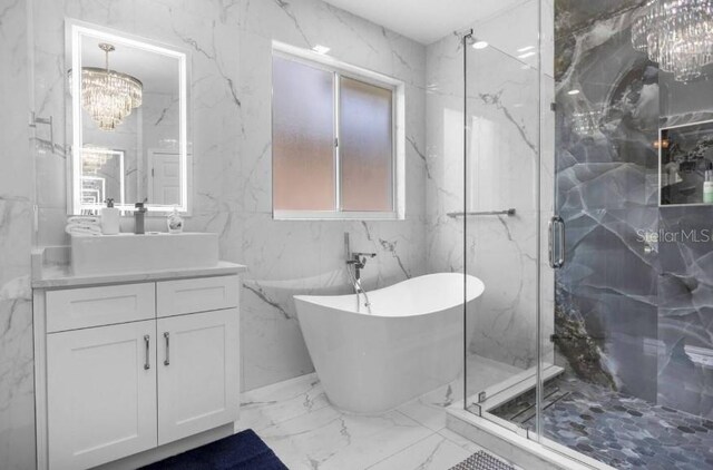 2912 Sunset Lakes Blvd, Kissimmee, FL 34747 - bathroom featuring marble tiled floors, a chandelier, vanity, a soaking tub, and a marble finish shower