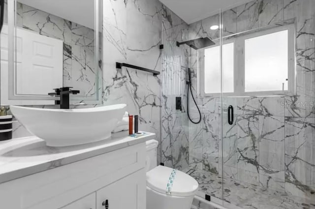 2912 Sunset Lakes Blvd, Kissimmee, FL 34747 - full bathroom with vanity, a marble finish shower, toilet, tile walls, and marble finish flooring