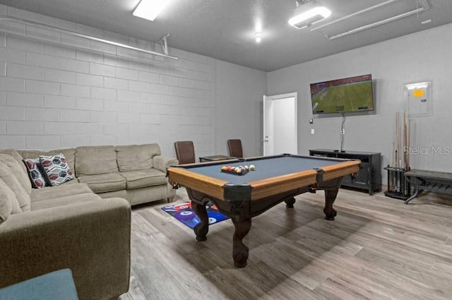 game room with hardwood / wood-style floors, electric panel, and billiards