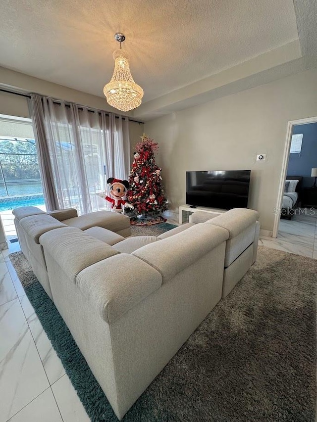 living room featuring a chandelier and a textured ceiling