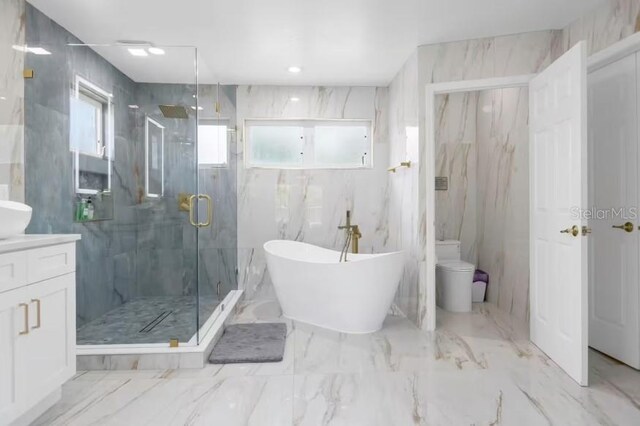 2912 Sunset Lakes Blvd, Kissimmee, FL 34747 - full bathroom with vanity, a marble finish shower, a soaking tub, toilet, and marble tiled flooring
