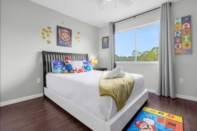 bedroom with ceiling fan and dark hardwood / wood-style flooring