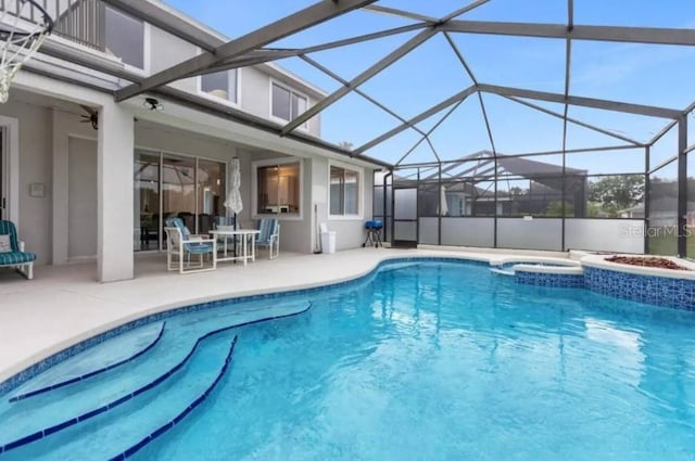 view of pool featuring a lanai, a patio, and an in ground hot tub