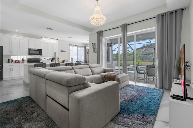 living room with a wealth of natural light and a chandelier