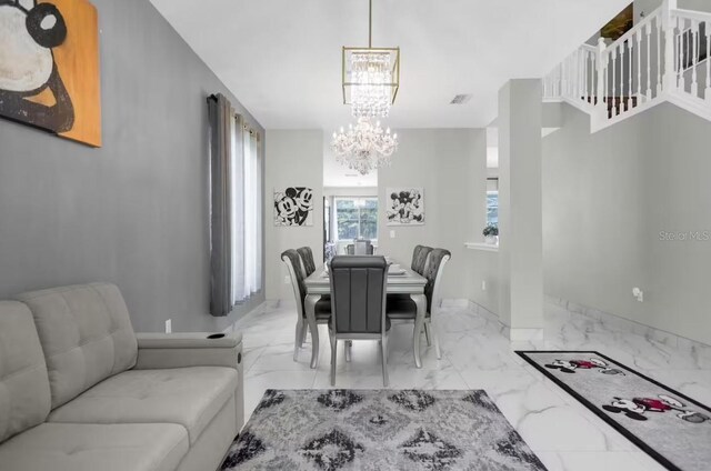 dining area featuring a notable chandelier