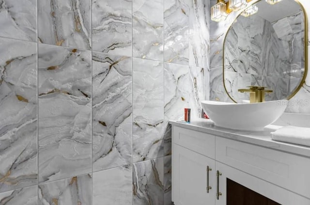 bathroom featuring vanity and tile walls