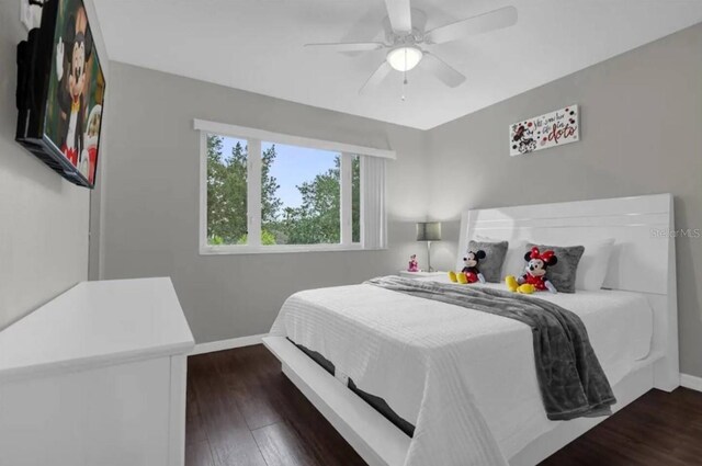 2912 Sunset Lakes Blvd, Kissimmee, FL 34747 - bedroom with baseboards, dark wood-style floors, and a ceiling fan