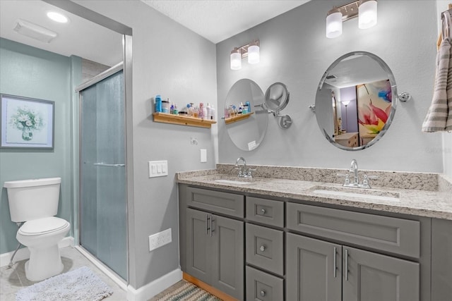 bathroom featuring vanity, an enclosed shower, and toilet