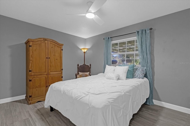 bedroom with hardwood / wood-style flooring and ceiling fan