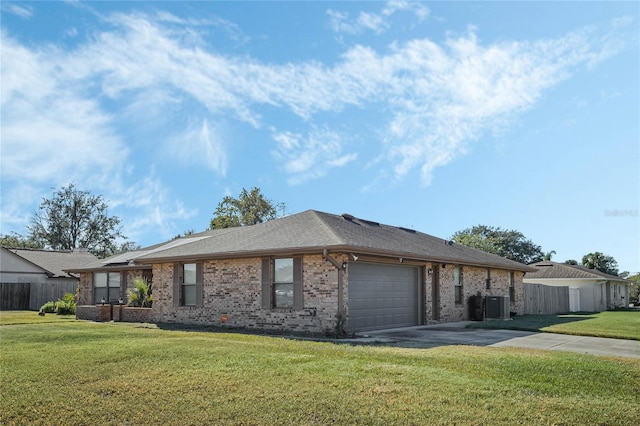 view of front of property with cooling unit, a garage, and a front lawn