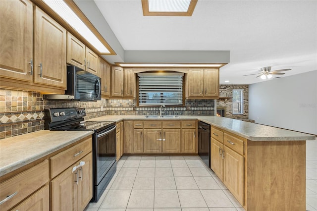 kitchen with ceiling fan, sink, kitchen peninsula, light tile patterned flooring, and black appliances