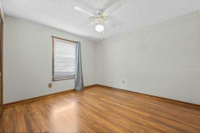 unfurnished room with hardwood / wood-style floors, a textured ceiling, and ceiling fan