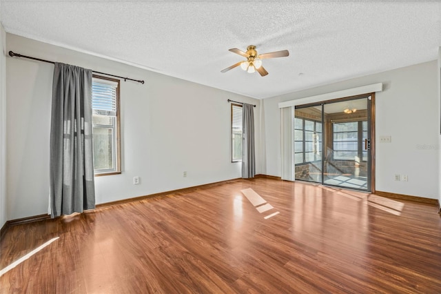 spare room with hardwood / wood-style flooring and a textured ceiling