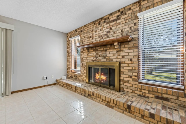 unfurnished living room with a textured ceiling, light tile patterned floors, and a fireplace