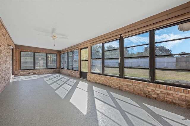 unfurnished sunroom with ceiling fan and lofted ceiling