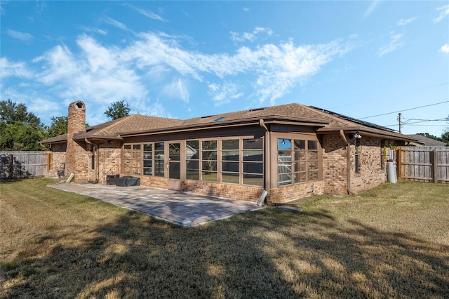 back of property with a patio and a lawn