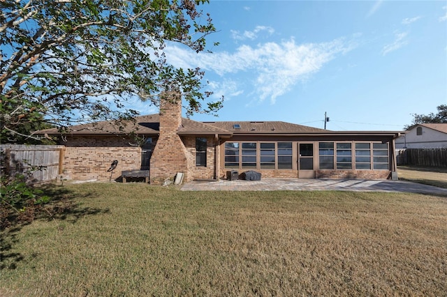 back of property featuring a yard and a patio area