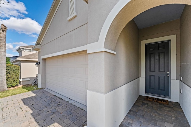 entrance to property with stucco siding