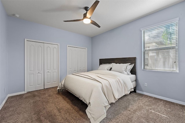 bedroom with multiple closets, carpet, baseboards, and a ceiling fan