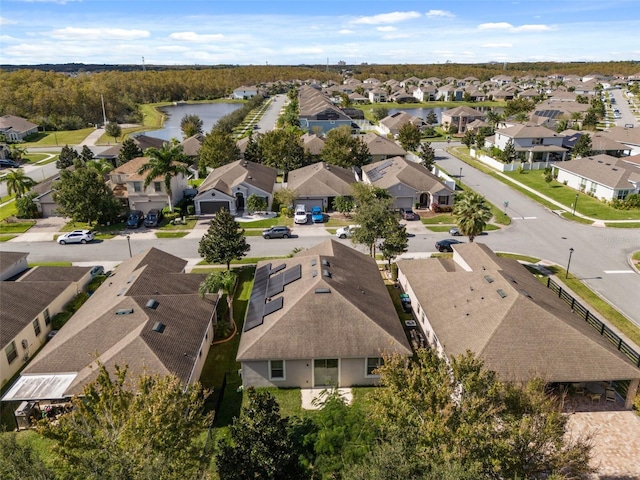 drone / aerial view featuring a water view and a residential view