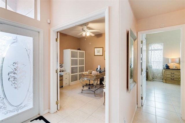 tiled foyer with ceiling fan and a wealth of natural light