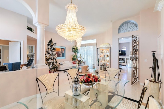 dining space with a chandelier, decorative columns, and light tile patterned floors