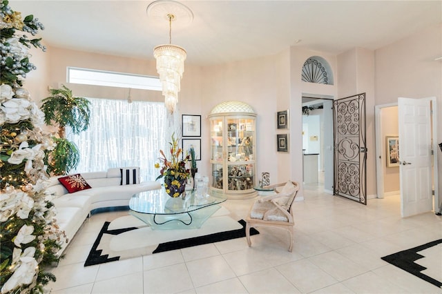 living room with an inviting chandelier and light tile patterned flooring