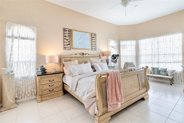 tiled bedroom featuring ceiling fan