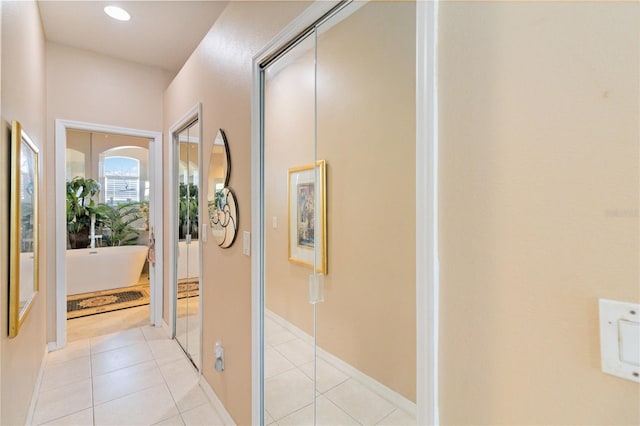 hall featuring light tile patterned floors