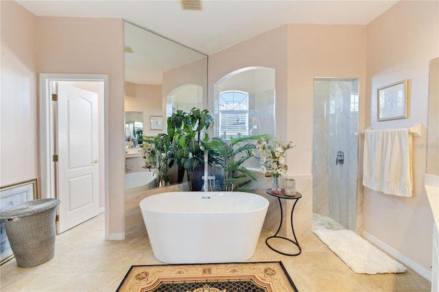 bathroom featuring tile patterned floors, separate shower and tub, and vanity