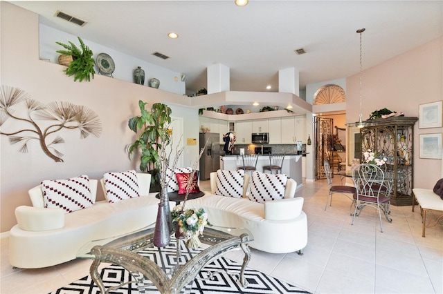 tiled living room featuring a high ceiling