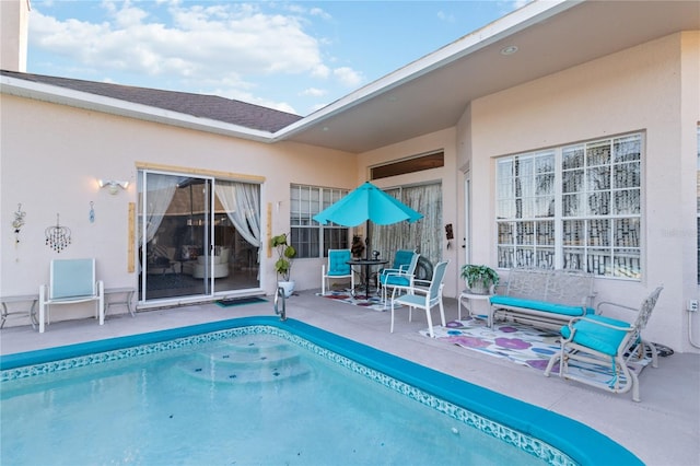 view of swimming pool with a patio area