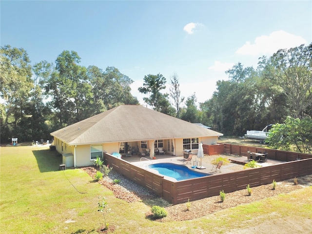 view of swimming pool with a lawn and a patio