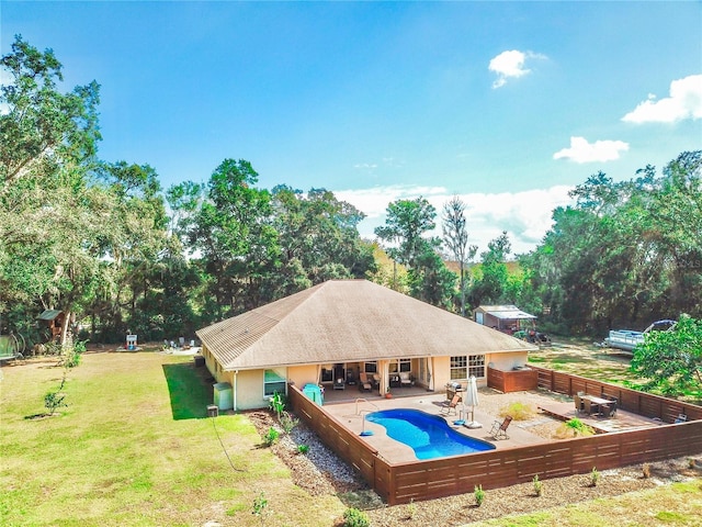 view of swimming pool with a yard and a patio area