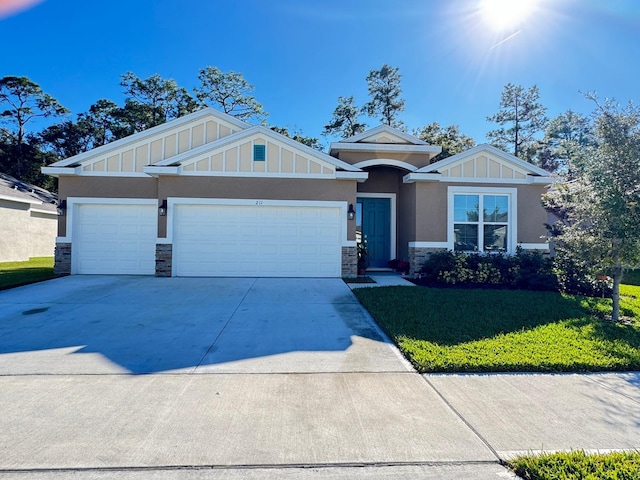 view of front of house with a front yard and a garage