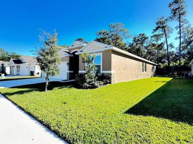 view of front of home featuring a front yard and central AC