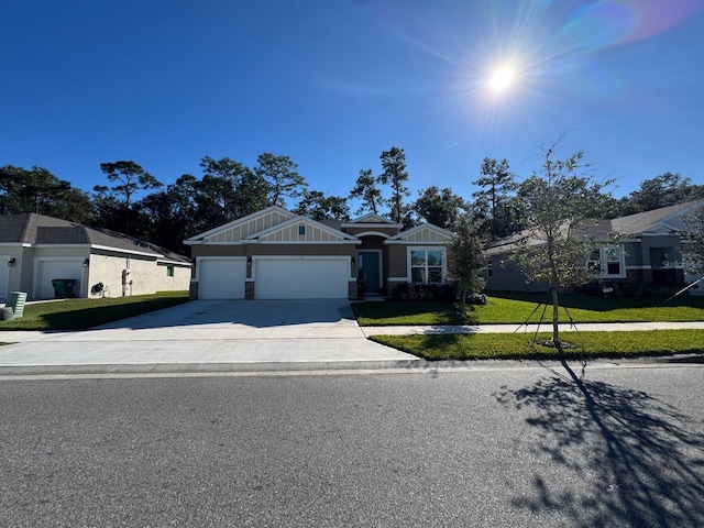 ranch-style home with a garage and a front lawn