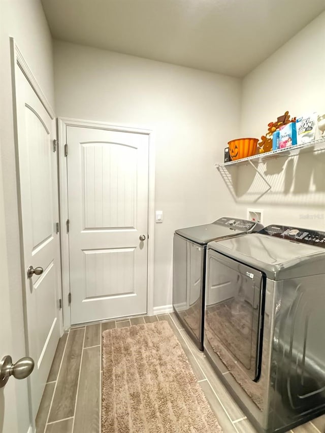 washroom featuring hardwood / wood-style flooring and washer and dryer