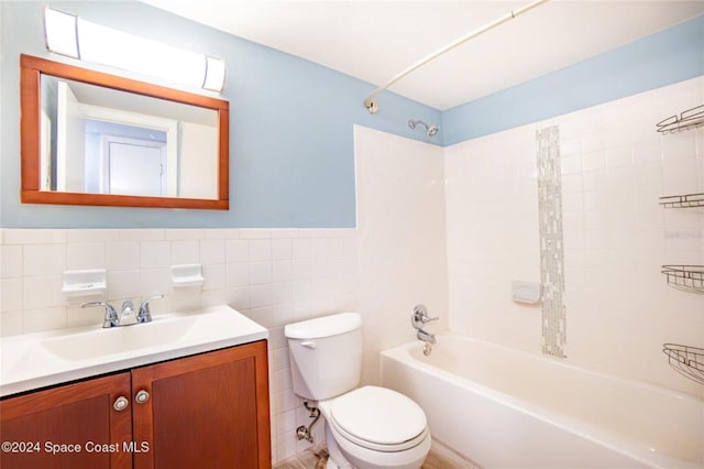 full bathroom with vanity, tiled shower / bath combo, tile walls, and toilet