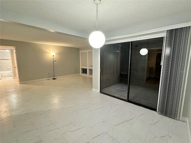 spare room featuring a textured ceiling